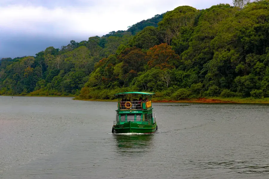 Boat cruise on Periyar lake surrounded by forest in Thekkady, Kerala
