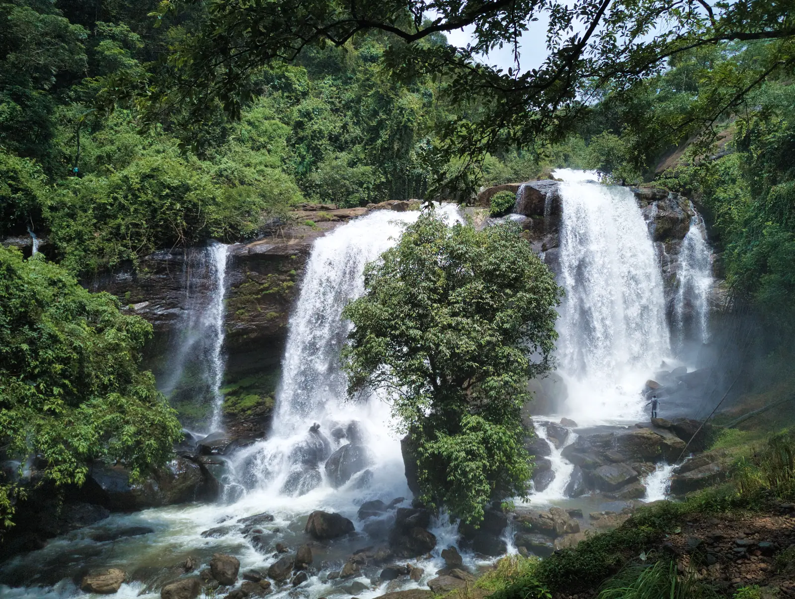Waterfalls tumbling through lush tropical forest in Wayanad, Kerala