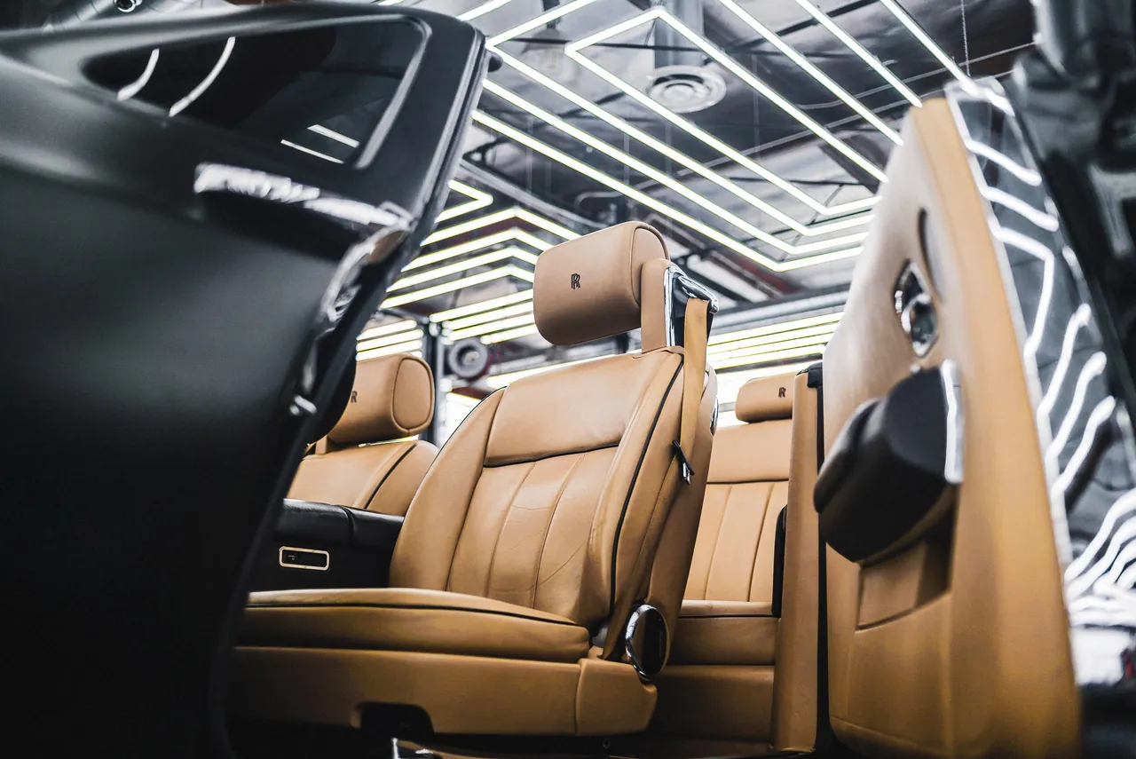 comfortable car interior leather seats, Kerala mountains visible through window, warm ambient lighting